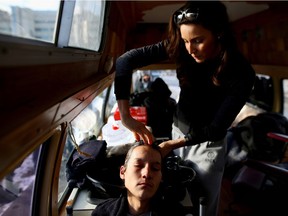 File photo of Misty Wind Shingoose giving one of her free haircuts in her old Care Cut van. The licensed stylist cruises the street giving free haircuts to the downtrodden.