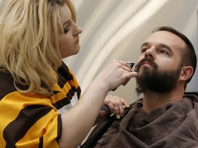 Carlee Hansen shaves Curtis Lesperance during Kick Off Movember at Best of Seven Barbers in Calgary on Wednesday November 1, 2017. Leah Hennel/Postmedia