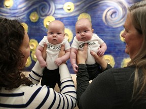 Cynthia Cote, left, and Christine Olson with their twins Beatrice and Alexander Cote-Olson pose for a portrait at NorthernStar Mothers Milk Bank in Calgary.