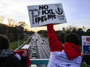 Opponents of the Keystone XL pipeline demonstrate on the Dodge Street pedestrian bridge during rush hour in Omaha, Neb., on Nov. 1, 2017. Five commissioners in Nebraska are set to vote today on the fate of TransCanada's Keystone XL pipeline, potentially clearing the last major regulatory hurdle of a project once thought dead. The Nebraska Public Service Commission will be voting on whether the project, which would transport about 830,000 barrels of oil a day from Alberta to various U.S. markets, serves the public interest. THE CANADIAN PRESS/AP, Nati Harnik ORG XMIT: CPT504

EDS NOTE A FILE PHOTO
Nati Harnik,