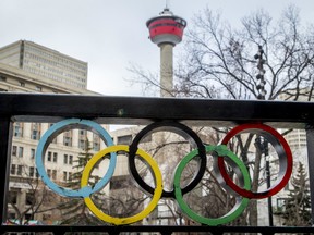 The Calgary Tower is seen with Olympic rings built into railing at Olympic Plaza in downtown Calgary, Alta., on Monday, March 20, 2017. The city is considering another Winter Olympics bid.