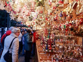 Visitors look at Christmas decorations for sale at the traditional Christmas market 'Nuernberger Christkindlesmarkt' ahead of the opening ceremony on November 30, 2012 in Nuremberg, Germany. Originated in the 16th century the Nuremberg Christmas market is seen as one of the oldest of its kind in Germany.