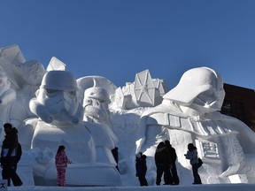 Visitors gather around a large snow sculpture called the snow "Star Wars" produced by the Japan Ground Self-Defense Force during the 66th annual Sapporo Snow Festival. AFP-Getty Images