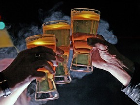 People toasting with a glass of beer.