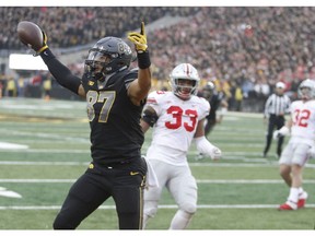 Tight end Noah Fant #87 of the Iowa Hawkeyes celebrates a touchdown during the second quarter in front of linebacker Dante Booker #33 of the Ohio State Buckeyes on November 04, 2017 at Kinnick Stadium in Iowa City, Iowa. (Photo by Matthew Holst/Getty Images)