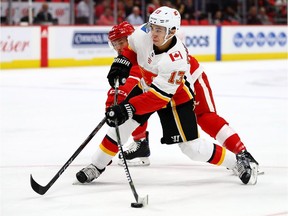 Calgary Flames v Detroit Red Wings DETROIT, MI - NOVEMBER 15: Johnny Gaudreau #13 of the Calgary Flames tries to control the puck in front of Luke Glendening #41 of the Detroit Red Wings during the first period at Little Caesars Arena on November 15, 2017 in Detroit, Michigan. (Photo by Gregory Shamus/Getty Images) Gregory Shamus, Getty Images