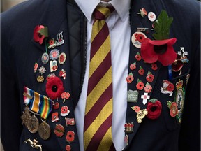 Mark Drewekk of the Royal Regiment of Fussiliers wears badges and poppies on his jacket as he stands in the Field of Remembrance at Westminster Abbey in central London on November 11, 2017, the Armistice Day.  On Armistice Day, many Britons wear a paper red poppy -- symbolising the poppies which grew on French and Belgian battlefields during World War I -- in their lapels. / AFP PHOTO / CHRIS J RATCLIFFECHRIS J RATCLIFFE/AFP/Getty Images
CHRIS J RATCLIFFE, AFP/Getty Images