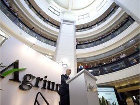 Agrium president Chuck Magro speaks as employees look down from upper floors, during the company's annual general meeting in this 2014 file photo.