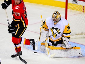Calgary Flames Sam Bennett attempts to redirect a puck past goalie Tristan Jarry of the Pittsburgh Penguins during NHL hockey at the Scotiabank Saddledome in Calgary on Thursday, Nov. 2, 2017.