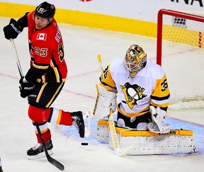 Calgary Flames Sam Bennett attempts to redirect a puck past goalie Tristan Jarry of the Pittsburgh Penguins during NHL hockey at the Scotiabank Saddledome in Calgary on Thursday, Nov. 2, 2017.