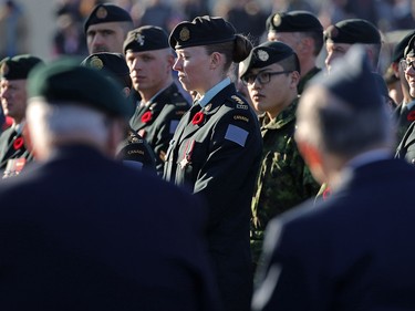 Veterans in the foreground and current armed forces members pay their respects at the cenotaph during Remembrance Day ceremonies at the Military Museums in Calgary on  Saturday November 11, 2017.