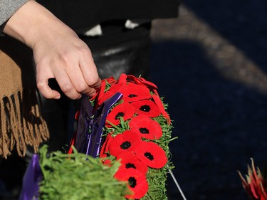 Calgarians place poppies on wreaths at the cenotaph during Remembrance Day ceremonies at the Military Museums in Calgary on  Saturday November 11, 2017.