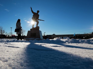 Calgarians walk past a statue honouring First World War veterans during Remembrance Day ceremonies at the Military Museums in Calgary on  Saturday November 11, 2017.