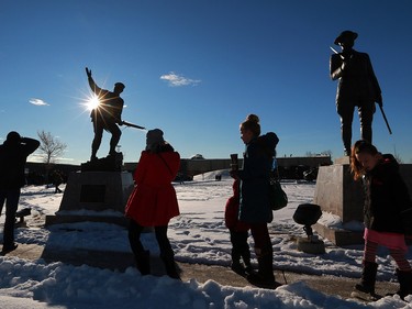 Calgarians walk past a statue honouring Second and First World War veterans during Remembrance Day ceremonies at the Military Museums in Calgary on  Saturday November 11, 2017.