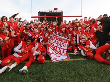 The U of C Dinos celebrate winning the Hardy Cup over the UBC Thunderbirds after Niko Difonte kicked a game-winning 59-Yard goal in the closing seconds to win the game 44-43.