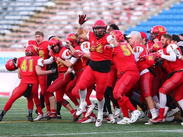 The U of C Dinos mob kicker Niko Difonte #45 after he kicked a game-winning 59-Yard goal in the closing seconds of the game to win the Hardy Cup over the UBC Thunderbirds 44-43.