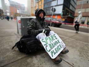 Tom asks for spare change along Centre Street in downtown Calgary on Nov. 15, 2017.