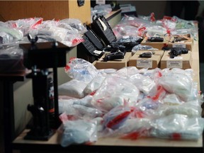 Drugs, weapons and cash are displayed at a press conference in Calgary announcing a record $4-million drug seizure on Wednesday, November 22, 2017.