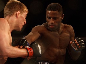 Hakeem Dawodu (blue gloves), from Calgary, fights Jake McDonald, from Kelowna, B.C., during the World Series of Fighting mixed martial arts fight held at the Edmonton Expo Centre in Edmonton, Alta., Saturday June 7, 2014.