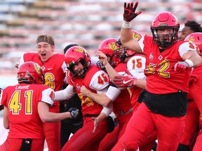 The U of C Dinos mob kicker Niko Difonte #45 after he kicked a game-winning 59-Yard goal in the closing seconds of the game to win the Hardy Cup over the UBC Thunderbirds 44-43 Saturday at McMahon Stadium.