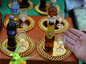 Buyers choose their deceased loved one's favourite beverage from these tiny miniatures on sale in the plaza outside Cusco's Almudena Cemetery. These and other miniatures, from pets to food to hobbies, commemorate what they loved in life and are added to their glass-fronted coffin niche on Day of the Dead. Courtesy, Reid Storm