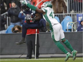 James Wilder Jr., left, of the Toronto Argonauts makes a crucial catch as the Saskatchewan Roughriders' Samuel Eguavoen attempts to thwart the reception on Sunday at BMO Field.
