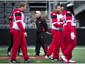Calgary Stampeders head coach Dave Dickenson, centre, watches during practice ahead of the105th Grey Cup championship football game against the Toronto Argonauts in Ottawa on Saturday, November 25, 2017. THE CANADIAN PRESS/Nathan Denette