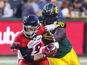 Calgary Stampeders quarterback Bo Levi Mitchell (19) gets sacked by Edmonton Eskimos' Almondo Sewell (90) during first half CFL action in Edmonton, Alta., on Saturday September 9, 2017. The Calgary Stampeders are aware of the doubts. After all, they created them.The team that finished first in the CFL with a 13-4-1 record doesn't have much momentum heading into Sunday's West Division final against the Edmonton Eskimos, who went 12-6. THE CANADIAN PRESS/Amber Bracken ORG XMIT: CPT140 EDS NOTE A FILE PHOTO AMBER BRACKEN,