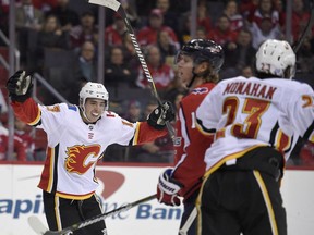 Calgary Flames left wing Johnny Gaudreau (13) celebrates a goal by center Sean Monahan (23) during the second period.