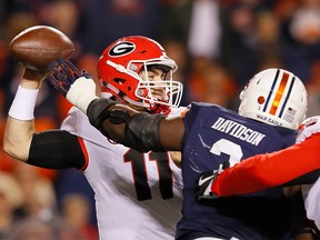 Marlon Davidson #3 of the Auburn Tigers pressures Jake Fromm #11 of the Georgia Bulldogs at Jordan Hare Stadium on November 11, 2017 in Auburn, Alabama.