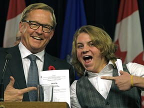 Alberta Education Minister David Eggen (left) and transgender student Ace Peace with a copy of Bill 24 on the day it was introduced in the legislature.