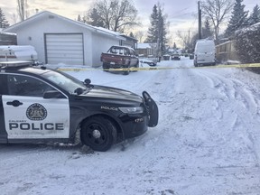 A police car is parked outside a Ranchlands alley where a man's body was discovered in a vehicle. Police have deemed his death to be suspicious and are investigating. Jim Wells/Postmedia