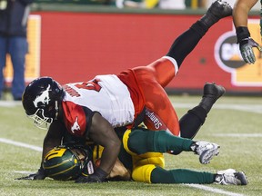 Calgary Stampeders' Micah Johnson sacks Edmonton Eskimos quarterback Mike Reilly (13) during first half CFL action in Edmonton, Alta., on Saturday September 9, 2017.