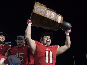 Laval Rouge et Or Benoit Gagnon-Brousseau celebrate winning the USports Dunsmore Cup for the provincial title against the Montreal Carabins, in Quebec City on Saturday, Nov. 11, 2017.