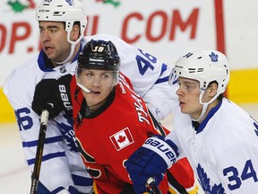 Calgary Flames Matthew Tkachuk battles Auston Matthews, right, of the Toronto Maple Leafs in a game last season.