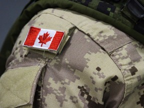 A Canadian flag patch is shown on a soldier's shoulder.