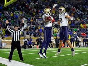 Navy wide receiver Craig Scott celebrates a touchdown catch with Tyler Carmona against Notre Dame on Nov. 18, 2017