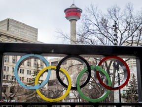 The Calgary Tower is seen with Olympic rings built into railing at Olympic Plaza.