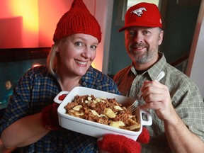 Julie Van Rosendaal and her husband Mike Semenchuk with a hot dish of Pulled Pork Poutine.
