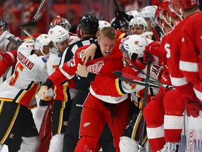 Anthony Mantha of the Detroit Red Wings gets in a fight with Travis Hamonic of the Calgary Flames during the third period on November 15, 2017 in Detroit.