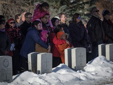 Calgarians listen to the Last Post during a Remembrance Day service in Calgary, Saturday, Nov. 11, 2017.