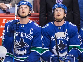 Vancouver Canucks' Henrik Sedin, left, and his twin brother Daniel Sedin.