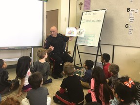 File photo: Constable Don Johnson, a Calgary police school resource officer, speaks to a Grade 1 class at St. Augustine School.