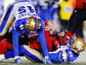 Stampeders quarterback Andrew Buckley is sacked by Tristan Okpalaugo of the Winnipeg Blue Bombers during CFL football on Friday, November 3, 2017.