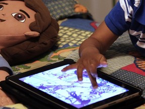 A child plays with an iPad in his bedroom. A new study from the University of Calgary has linked increased screen time among young children to a failure to meet expected developmental milestones.
