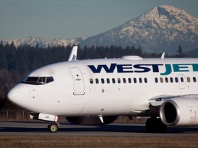 A pilot taxis a Westjet Boeing 737-700 plane to a gate after arriving at Vancouver International Airport.