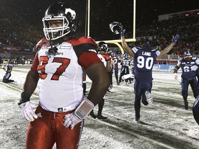 Calgary's Derek Wiggan walks off the field dejected after losing the Grey Cup on Nov. 26, 2017.