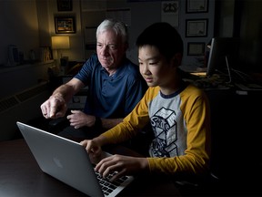 Phil Butterfield, principal at Connect Charter School, left and Grade 7 student Joseph Song pose for photos at the school in Calgary, on Wednesday December 6, 2017.  to illustrate the school's unique coding programs for students Leah Hennel/Postmedia