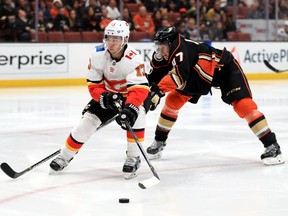 Johnny Gaudreau #13 of the Calgary Flames skates past Hampus Lindholm #47 of the Anaheim Ducks during the second period of a game at Honda Center on December 29, 2017 in Anaheim, California.