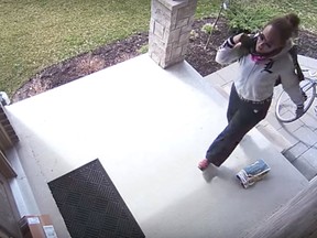London police are investigating after a video posted online shows a bike-riding woman snatch a package from a porch. The 35-second clip shows a woman on a racing bike casually ride up the driveway of a home and pick up a parcel that was dropped at the front door. The woman, wearing a white hoodie and sunglasses, stuffs the box into her backpack before peddling away.  SCREEN GRABE OF SURVEILLANCE VIDEO